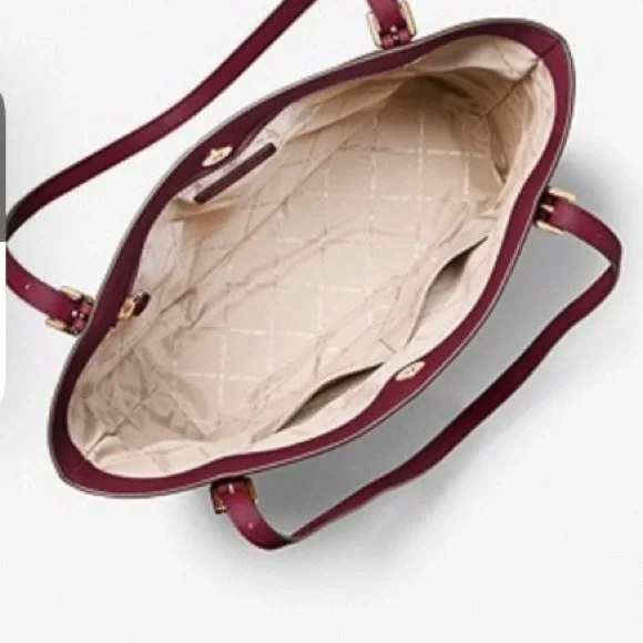 MK Megan Large Saffiano Leather Tote.
Don’t use large purses anymore. Burgundy - Picture 3 of 5